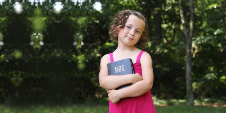 A little girl holding her Bible